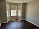 Bedroom featuring three windows with wood-look flooring at 1251 N Burlington Dr, Castle Rock, CO 80104