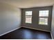 Bedroom featuring two windows with wood-look flooring at 1251 N Burlington Dr, Castle Rock, CO 80104
