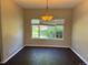 Cozy dining room with warm paint, dark wood floors, and a window overlooking the greenery outside at 1251 N Burlington Dr, Castle Rock, CO 80104