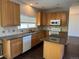 Functional kitchen features an island, granite countertops, wooden cabinets, and modern appliances at 1251 N Burlington Dr, Castle Rock, CO 80104