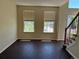 Inviting living room featuring dark wood floors, neutral walls, and natural light from the large windows at 1251 N Burlington Dr, Castle Rock, CO 80104