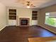 Spacious living room highlighted by a brick fireplace, built-in shelving, and a cozy atmosphere at 1251 N Burlington Dr, Castle Rock, CO 80104