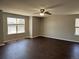 Expansive primary bedroom includes a ceiling fan, neutral walls, and large windows for ample natural light at 1251 N Burlington Dr, Castle Rock, CO 80104
