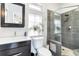 Modern bathroom features glass enclosed shower, tiled walls, updated sink and vanity, with natural light at 4138 N Federal Blvd, Denver, CO 80211