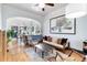 Cozy living room featuring hardwood floors, ceiling fan, modern décor, and decorative archway to dining area at 4138 N Federal Blvd, Denver, CO 80211