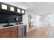Stylish wet bar with dark backsplash, wood cabinets, and wine cooler at 4505 S Yosemite St # 362, Denver, CO 80237