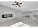 Carpeted living room with a modern electric fireplace and stairs at 13953 Forest St, Thornton, CO 80602