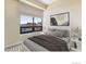 Bright bedroom featuring a large window with blinds, creating a cozy atmosphere for relaxation at 2990 E 17Th Ave # 604, Denver, CO 80206