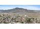 Elevated view of a cozy suburban area with neat houses, trees, and a mountain backdrop at 11826 W Stanford Pl, Morrison, CO 80465
