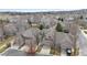 Aerial view of a residential neighborhood with well-manicured lawns and tree-lined streets at 11826 W Stanford Pl, Morrison, CO 80465