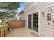 Private back deck with sliding glass door, wood flooring, and space for outdoor seating at 11826 W Stanford Pl, Morrison, CO 80465