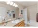 Bright bathroom with a vanity, neutral tile, and shower and tub combination at 11826 W Stanford Pl, Morrison, CO 80465
