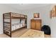 Cozy bedroom featuring a bunk bed, wood dresser, and a comfortable bean bag chair at 11826 W Stanford Pl, Morrison, CO 80465