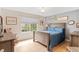 Charming bedroom features a wood bed frame, natural light, and a rocking chair at 11826 W Stanford Pl, Morrison, CO 80465