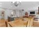 Open-concept dining and living area with hardwood floors, with modern light fixture at 11826 W Stanford Pl, Morrison, CO 80465