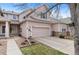 Attractive home exterior featuring a two-car garage and well-maintained landscaping at 11826 W Stanford Pl, Morrison, CO 80465