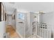 Upstairs hallway with wood flooring, natural light, and white railings at 11826 W Stanford Pl, Morrison, CO 80465