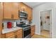 Modern kitchen features stainless steel appliances, wood cabinets, and granite countertops at 11826 W Stanford Pl, Morrison, CO 80465