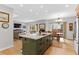 Bright, open-concept kitchen with an island, stainless steel appliances, and hardwood floors at 11826 W Stanford Pl, Morrison, CO 80465