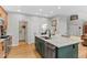 Spacious kitchen featuring a large island with modern appliances and a granite countertop at 11826 W Stanford Pl, Morrison, CO 80465