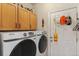 Well-organized laundry room with front load washer and dryer, and functional storage at 11826 W Stanford Pl, Morrison, CO 80465
