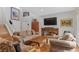 Comfortable living area boasting hardwood floors, a large TV, and stylish decor at 11826 W Stanford Pl, Morrison, CO 80465