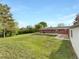 Expansive backyard featuring a lush lawn, mature trees, and a charming brick house at 12682 Anhawa Ave, Longmont, CO 80503