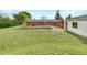 Spacious backyard with lush green grass, wooden fence, and detached garage at 12682 Anhawa Ave, Longmont, CO 80503