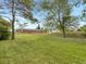 Expansive backyard with mature trees offering shade and privacy, along with a view of the detached garage at 12682 Anhawa Ave, Longmont, CO 80503