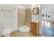 Updated bathroom features a corner shower, tile floors, and a vanity, all conveniently located off the main living area at 12682 Anhawa Ave, Longmont, CO 80503