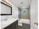 Renovated bathroom featuring a modern vanity, sleek fixtures, and tiled shower at 12682 Anhawa Ave, Longmont, CO 80503