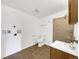 Compact bathroom features a single vanity, toilet, and a tiled stand-up shower with washer/dryer hookups at 12682 Anhawa Ave, Longmont, CO 80503