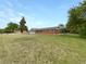 Charming single-story brick home with a well-maintained lawn and mature tree at 12682 Anhawa Ave, Longmont, CO 80503