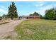 Cozy single-story home featuring a brick exterior, well-maintained lawn, and a long, private driveway at 12682 Anhawa Ave, Longmont, CO 80503