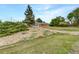 Charming single-story brick home featuring an enclosed porch and complemented by beautiful landscaping and a lush lawn at 12682 Anhawa Ave, Longmont, CO 80503