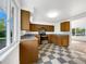 Functional kitchen featuring stainless appliances and checkerboard flooring near a large window at 12682 Anhawa Ave, Longmont, CO 80503