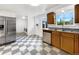 Bright kitchen with stainless steel appliances, checkerboard floors, and wood cabinets at 12682 Anhawa Ave, Longmont, CO 80503