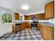 Well-lit kitchen with stainless steel appliances, ample oak cabinets, and retro checkered flooring at 12682 Anhawa Ave, Longmont, CO 80503