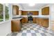 Functional kitchen featuring stainless appliances and checkerboard flooring near a large window at 12682 Anhawa Ave, Longmont, CO 80503