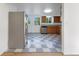 Cozy kitchen with stainless steel appliances, checkerboard floors, and wood cabinets at 12682 Anhawa Ave, Longmont, CO 80503