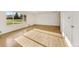 Bright and spacious living room with large window, wood flooring and fresh white walls at 12682 Anhawa Ave, Longmont, CO 80503
