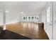 Bright living room featuring hardwood floors, natural light, and fresh, white walls, ready for your personal touch at 12682 Anhawa Ave, Longmont, CO 80503
