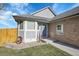 Charming front exterior featuring a brick accent and a decorative water wheel at 18383 E Union Dr, Aurora, CO 80015