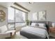 Bright bedroom with large window offering city views at 2001 Lincoln St # 1024, Denver, CO 80202
