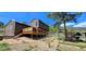Home featuring a spacious deck, garden area, and ample greenery, creating a serene outdoor living space at 18170 Forest View Rd, Monument, CO 80132
