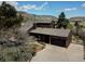 Exterior view of the home, a two-car garage, driveway, and surrounding trees at 18170 Forest View Rd, Monument, CO 80132
