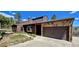 Charming exterior view of home featuring a two-car garage and lush landscaping at 18170 Forest View Rd, Monument, CO 80132