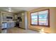 Bright kitchen featuring gray cabinets and stainless steel appliances with a view from a picture window at 18170 Forest View Rd, Monument, CO 80132