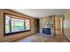 Living room with a window seat, hardwood floors, and a stone fireplace at 18170 Forest View Rd, Monument, CO 80132