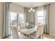 Bright dining area with natural light, a modern chandelier, and ample seating at 16113 Alpine Sorrel Dr, Monument, CO 80132